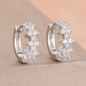 Detailed macro view of silver hoop earrings with two rows of sparkling cubic zirconia stones