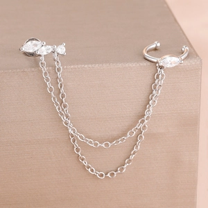 Detail of silver chain ear cuff earring with sparkling marquise zirconia and dual thin chains