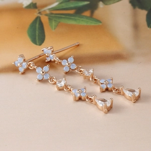 Elegant rose gold drop earrings featuring blue opal flowers and zircon crystals