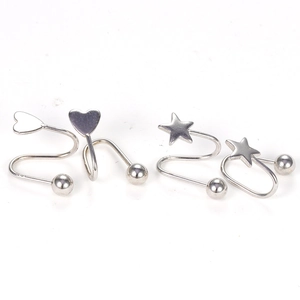 Macro shot of silver heart and star spiral stud earrings with polished ball ends