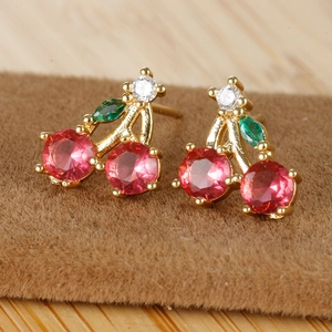 Close-up of cherry stud earrings with 18K gold plating and red cubic zirconia gems