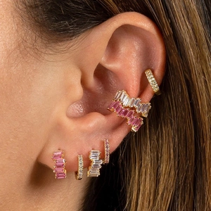 Set di orecchini a clip in oro 18k con zirconi rosa e bianchi indossati sul lobo