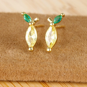 Macro shot of 18K gold plated lemon stud earrings with yellow and green marquise stones