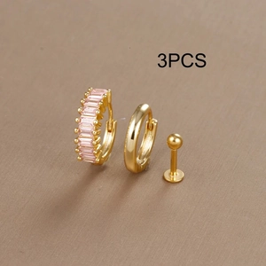 Macro shot of 3pcs gold hoop earrings and stud set featuring pink zircon stones