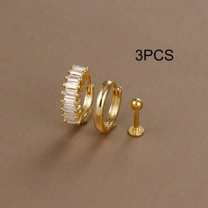 Close-up detail of a 3-piece gold jewelry set featuring a zircon huggie and polished stud
