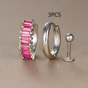 Detailed view of 3pcs earring set with silver hoop, red zircon, and ball stud on display