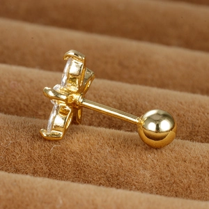 Macro side view of gold stainless steel daisy cartilage stud with white zircon inlay