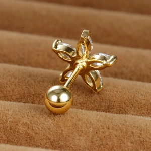 Macro shot of gold zircon daisy earring with 20G stainless steel screw ball back on velvet