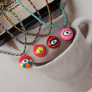 Bohemian colorful woven rope necklaces featuring evil eye and smiley face charms