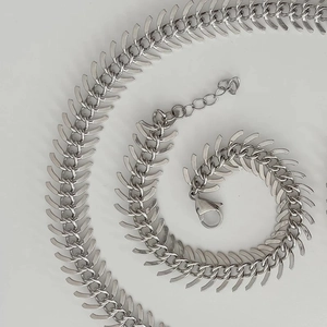 Macro view showing the polished silver fishbone chain links and lobster clasp detail