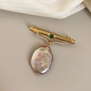 Baroque lavender freshwater pearl brooch with gold frame and green gemstone inlay