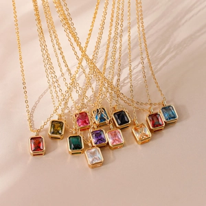 Macro display of rectangular faceted birthstone pendants on 18k gold plated chains