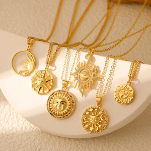 Detailed view of six vintage gold sun and moon pendants with colorful cubic zirconia