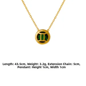 Detail view of Gemini zodiac pendant with green gemstone and gold extension chain