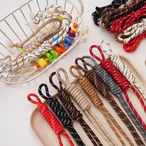 Handmade 5mm colorful polyester braided cords with decorative beads in a tray