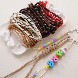Close-up of 5mm colorful braided polyester cords with star-shaped metal clasps and beads