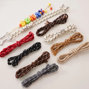 Close-up of 5mm colorful polyester ropes with woven patterns and DIY letter beads