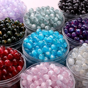 Macro shot of 10mm colorful resin beads for DIY jewelry making in clear plastic jars