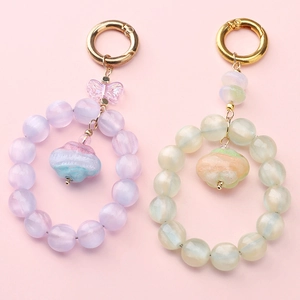 Detail of 10mm resin dream round beads with cloud pendant and gold spring clasp