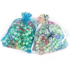 Bolsas de organza azul y blanco con estampado de ramas doradas llenas de perlas verdes