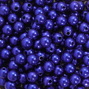 Macro shot of dark purple pearlescent ABS acrylic round beads for DIY jewelry making