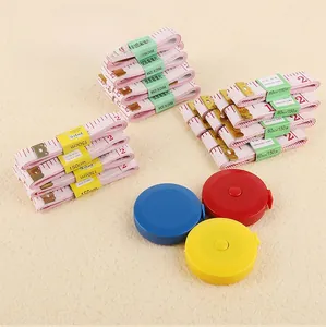 Macro view of 150cm pink sewing tapes and colorful retractable measuring tools