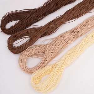 Detailed macro view of 1mm waxed polyester cords in four earth-toned colors for DIY jewelry