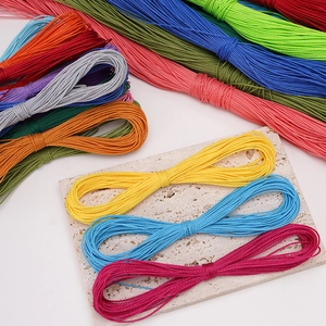 Macro shot of colorful 1mm polyester waxed cords for DIY jewelry weaving on marble surface