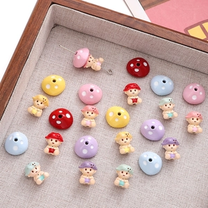 Macro view of colorful alloy mushroom charms and doll beads for DIY jewelry making