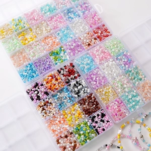 Close-up of organized multi-color glass seed beads set in a clear plastic storage box