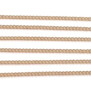 Detailed macro view of parallel gold-plated curb chains for jewelry making DIY