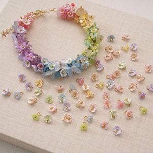 Rainbow gradient resin flower charm bracelet with star pendant and matching DIY beads