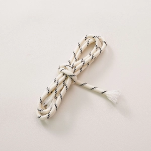 Detailed macro view of cream-colored braided polyester rope with black twill patterns