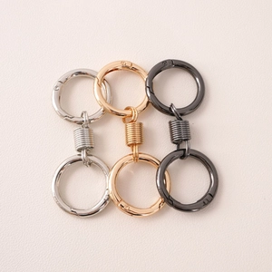 Detail of alloy spring O-rings in gold, silver, and gun black finishes on pink leather