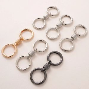 Close-up of metallic spring ring buckles in gold, silver, and gunmetal for DIY keychains