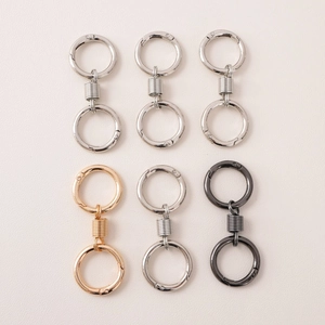 DIY metal spring dual keyrings in gold, silver, and gun black finishes on pink leather
