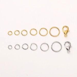 Macro view of assorted gold and silver jump rings and lobster clasps for jewelry DIY