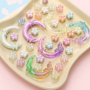 Macro detail of iridescent acrylic DIY beads in moon butterfly and flower shapes
