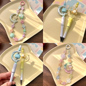Detailed macro view of macaron acrylic beads phone charms and gradient creative pens