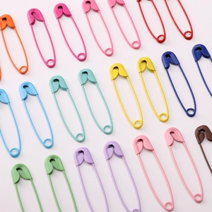 Close-up of colorful matte painted metal safety pins for DIY crafts and jewelry making