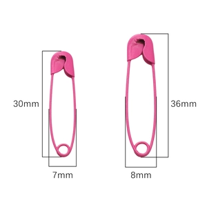 Macro detail of two bright pink matte painted safety pins with size dimensions for DIY crafts