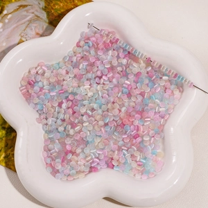 Close-up of colorful glass donut beads in a white floral tray for DIY jewelry making