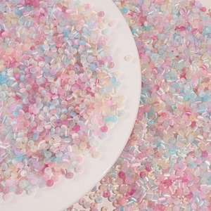 Macro shot of colorful glass donut beads in macaron pink and blue for DIY jewelry