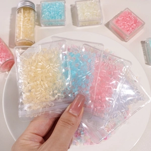 Detail of macaron color 4mm glass cat eye beads in plastic bags for DIY jewelry making