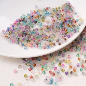 Macro detail of 4mm frosted glass beads with gold foil splatter for DIY jewelry making