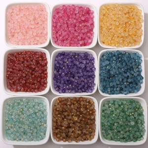 Macro detail of 4mm matte glass beads with gold foil in nine distinct colors for DIY
