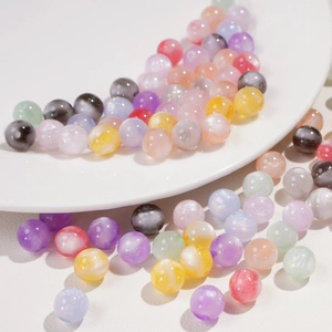 Close-up of 10mm resin beads with cat-eye effect and glitter for DIY jewelry making