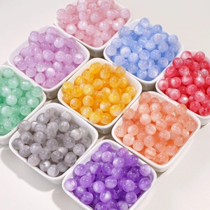 Detailed view of 10mm iridescent resin beads with cat-eye effect in multiple colors for DIY