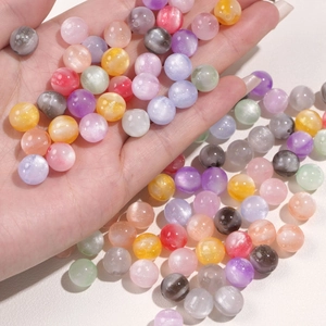 Close-up of 10mm resin beads with cat-eye luster for DIY handmade jewelry crafts