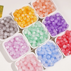 Close-up of 10mm iridescent resin beads in various colors for DIY jewelry making
